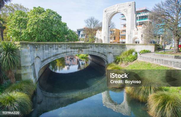 Cityscape Of Christchurch Downtown And The Bridge Of Remembrance Reflection On Avon River In Christchurch New Zealand Stock Photo - Download Image Now