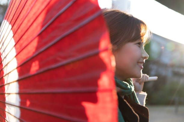 Korean woman putting up Japanese umbrella
