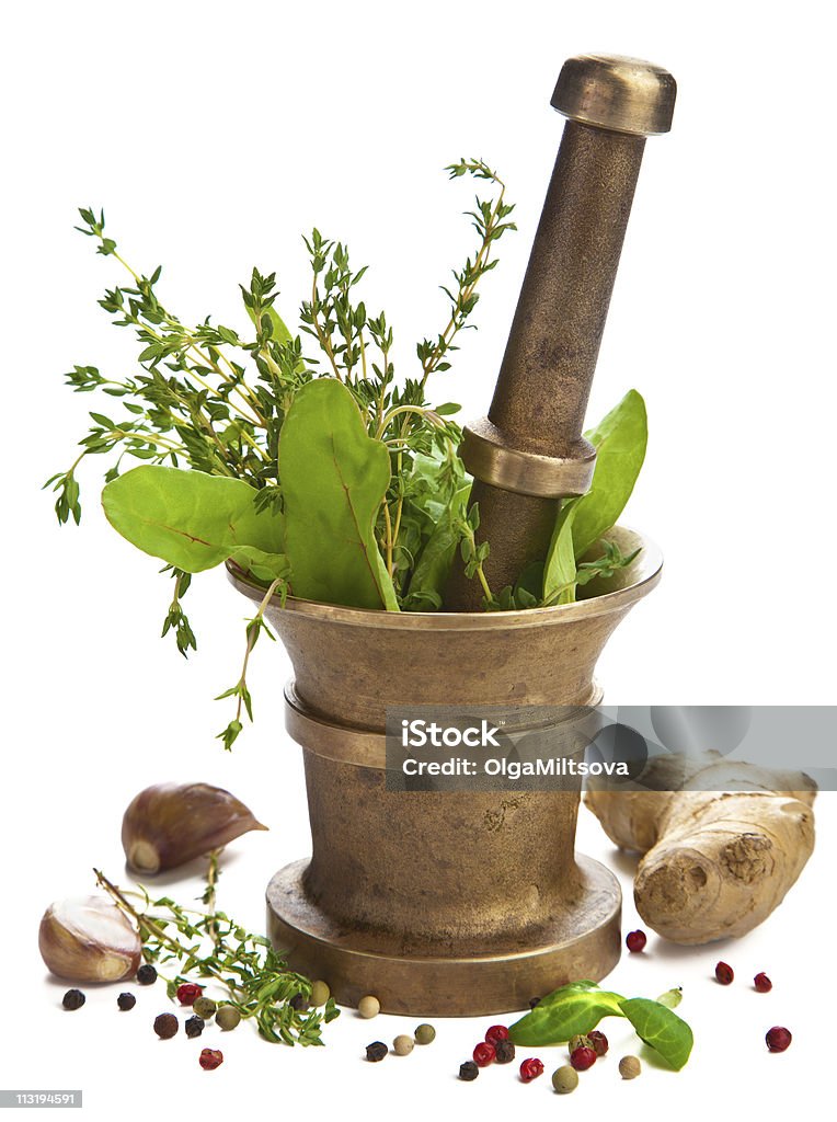 A pestle and mortar full of herbs and spices  mortar with herbs isolated Botany Stock Photo