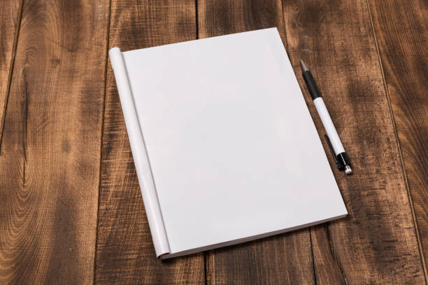 istock Mock-up magazine or catalog on wooden table. Blank page or notepad on wood background. Blank page or notepad for mockups or simulations 1131947327