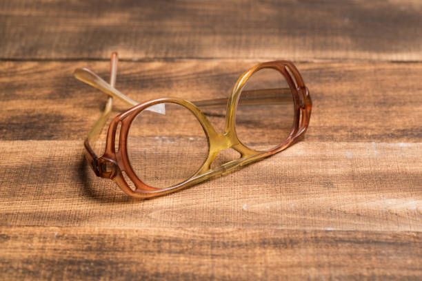istock A pair of glasses on a wooden table 1131947338