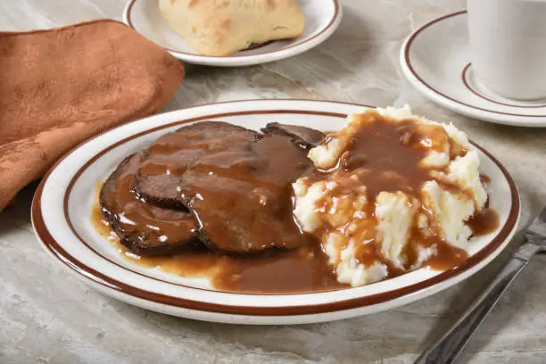 Delicious sliced roast beef with mashed potatoes and gravy