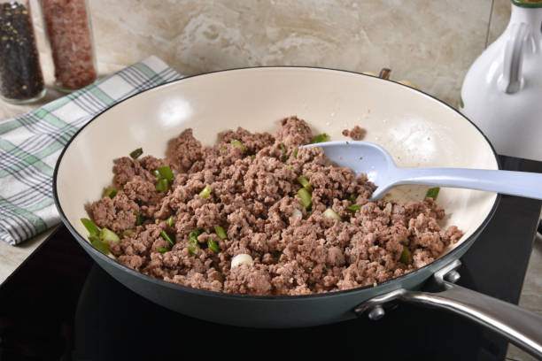 Cooked ground beef in a skillet Browned ground beef and onions in a cast iron skillet ground beef photos stock pictures, royalty-free photos & images
