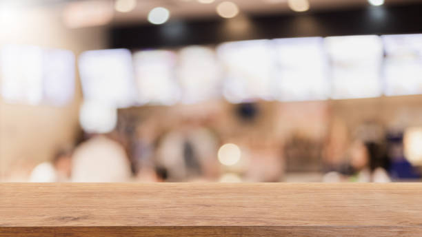 istock Empty wood table top and blurred bokeh cafe and restaurent interior background with vintage filter - can used for display or montage your products. 1131950068
