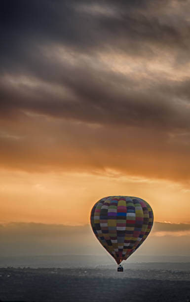istock Hot air balloon flying at sunrise 1131960123