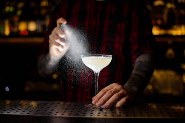 istock Bartender spraying on the Courpse Reviver cocktail from the vaporizer in the dark 1131960261