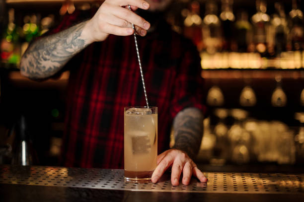 istock Bartender stirring a Lemonade cocktail with the spoon 1131960267