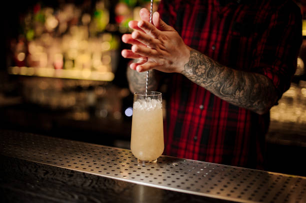 istock Bartender stirring a Trinidad Swizzle cocktail with the spoon 1131960305