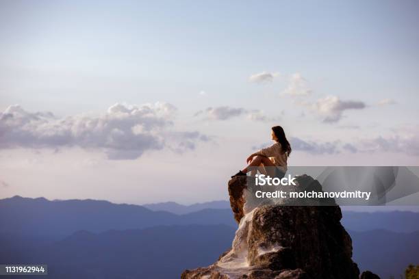 Beautiful Girl Sits Big Rock At Sunset Stock Photo - Download Image Now - Mountain, Women, One Woman Only