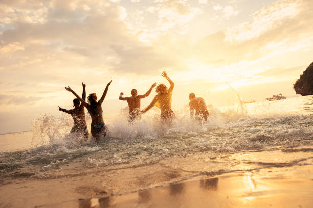 Happy friends at idyllic sea sunset