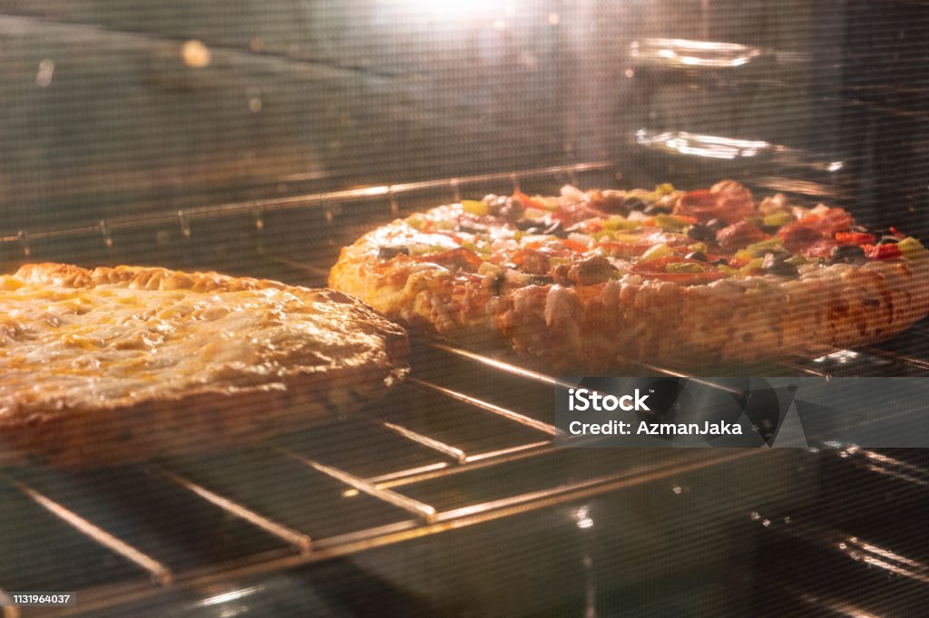 Pizza in an oven Pizza Stock Photo