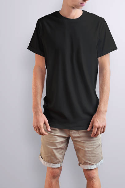 istock Stylish slim guy  in a black T-shirt on a white studio background. 1131964407