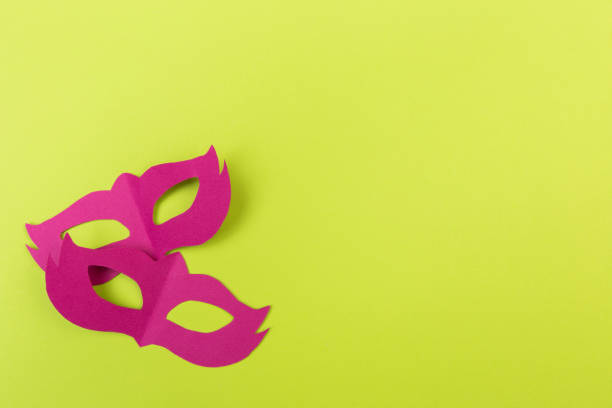 istock cut out colored paper figures for the holiday Mardi Gras, colour background 1131964540