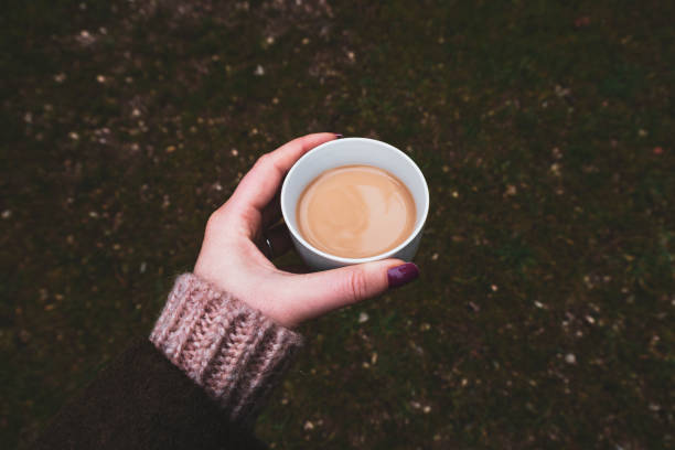 istock Hand holding coffee in nature 1131964741