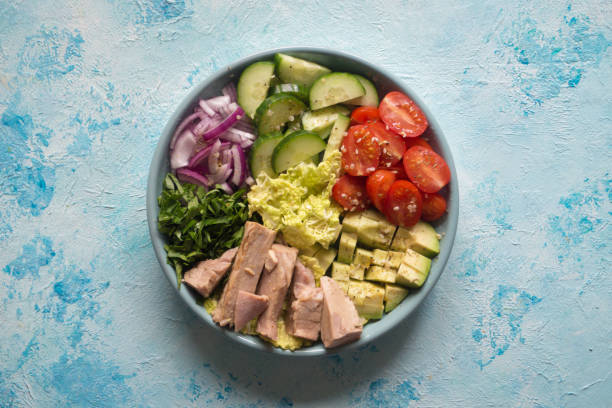 istock Avocado Tuna Salad in a plate on blue table. 1131965455