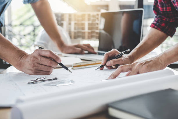 istock Construction and structure concept of Engineer or architect meeting for project working with partner and engineering tools on model building and blueprint in working site 1131974095