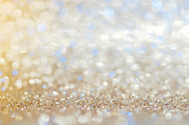 Blue,beige, Silver white abstract light background, shining lights, sparkling glittering Christmas lights. Blurred abstract holiday background.