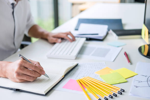 istock Businessman working writing making note business plan and graphic designer with computer in office 1131975995