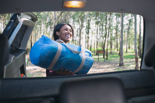 Woman packing for camping trip.