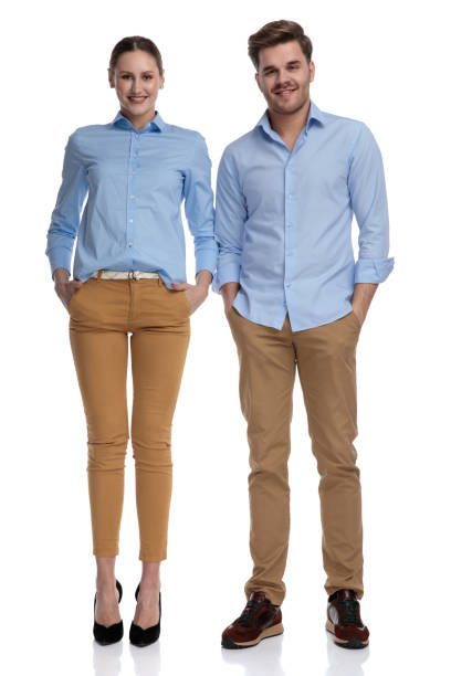 istock happy young casual couple standing with hands in pockets 1131979612