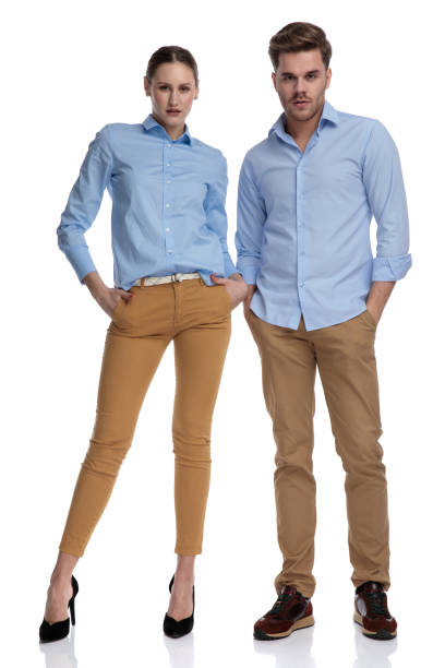 istock serious young casual couple standing with hands in pockets 1131981031