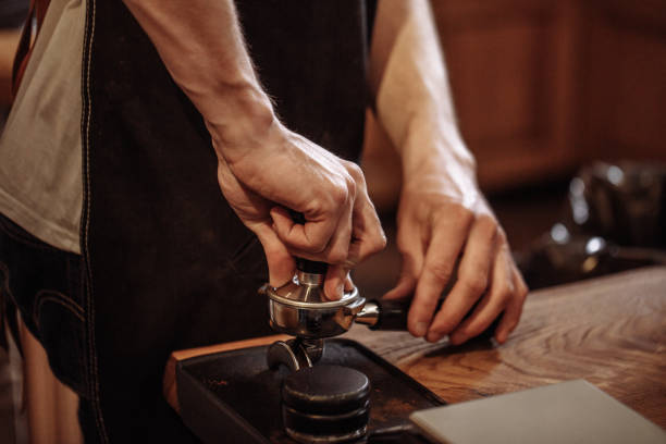 istock an experienced barista is tampering coffee beans. 1131981183