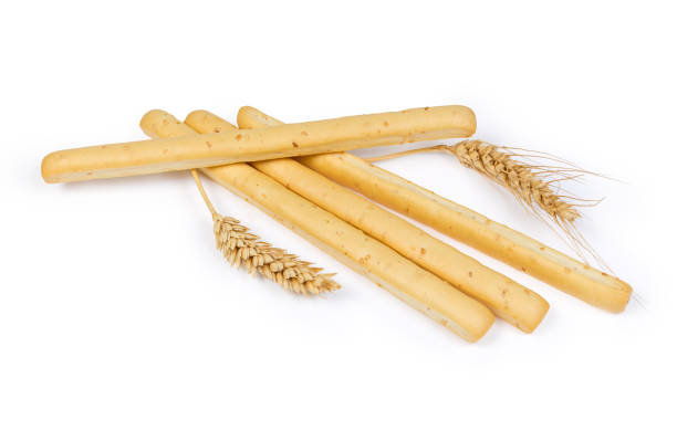 istock Breadsticks with sesame seeds and wheat ears on white background 1131981736