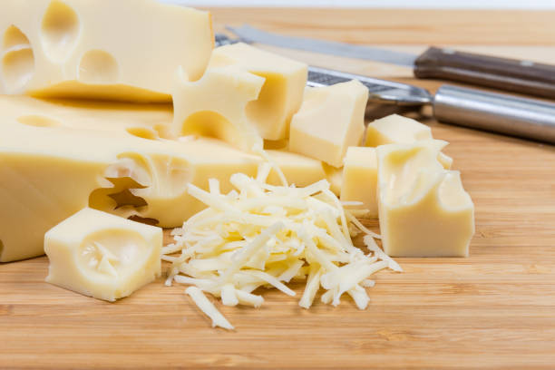 istock Sliced and grated Swiss cheese on cutting board close-up 1131981855