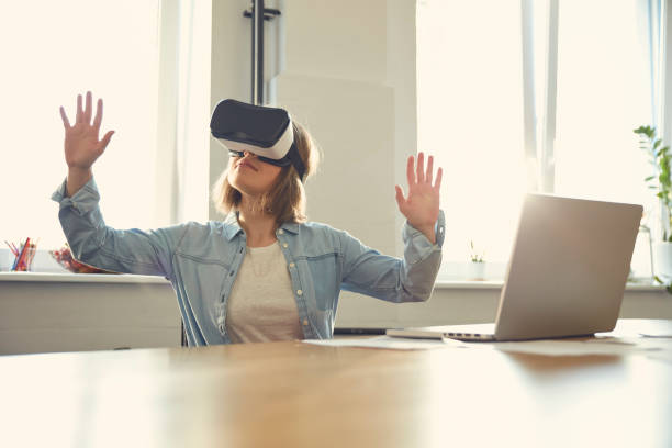 istock Young woman using virtual reality glasses at office. Designing 1131983690