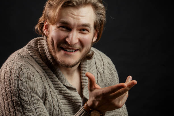 istock stylish male in sweater using his hands in conversation 1131983865