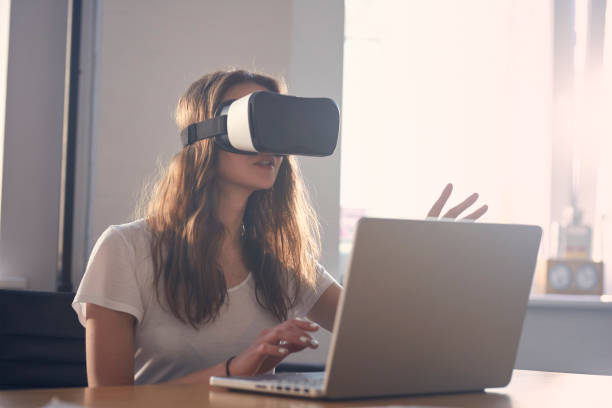 istock Young woman using virtual reality glasses at office. Designing 1131984855
