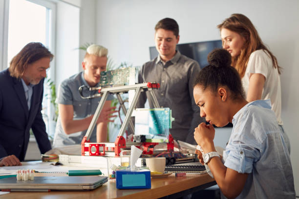istock Young team working on a device. Sick woman at work 1131985189