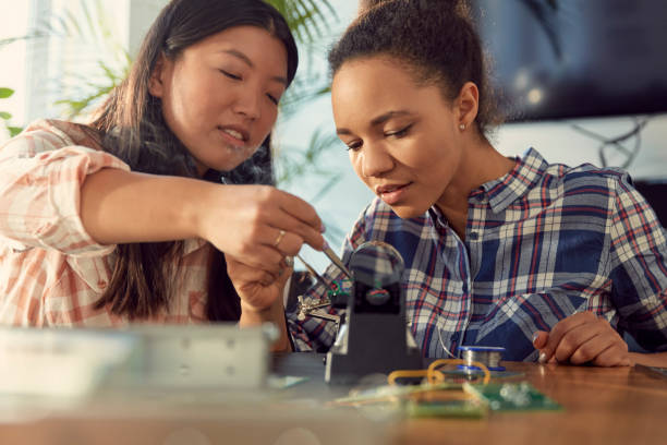 istock Young multi-ethnic female engeneers soldering device prototype 1131986614