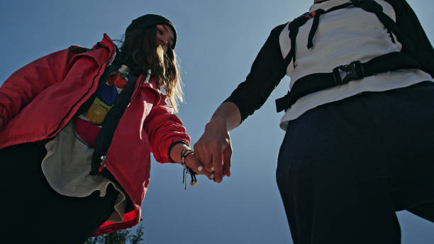 istock Young couple holding hands on a hike 1131987035