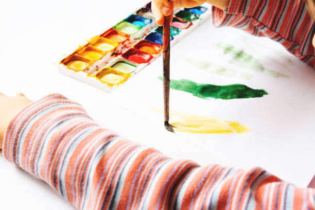 istock The child draws with watercolor paints 1131988631