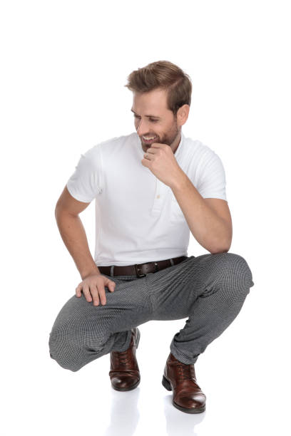 istock laughing crouched smart casual man thinks and looks to side 1131988733