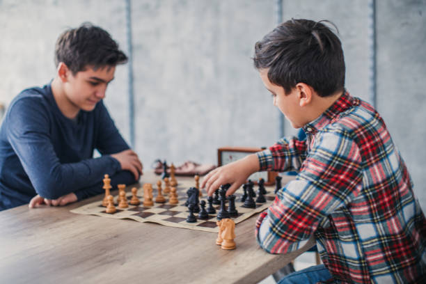 istock Smart boys playing chess in school of chess 1131988966
