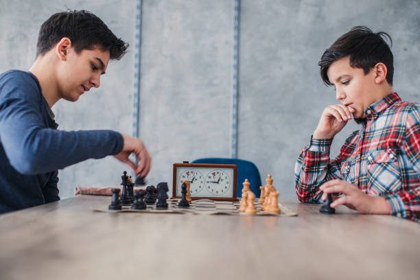 istock Two smart boys playing chess in school of chess 1131989002