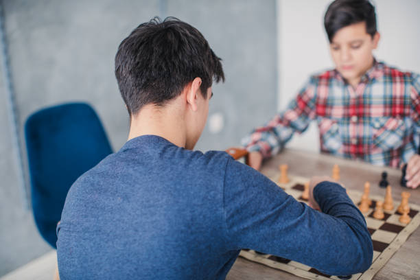 istock Boys playing a game of chess 1131992589