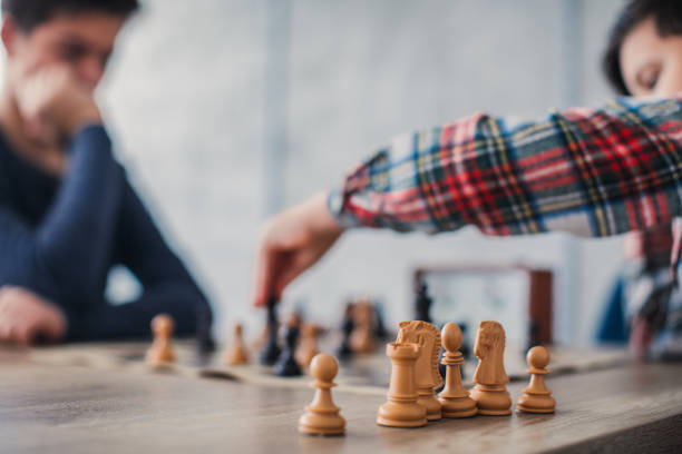 istock Two boys playing a game of chess 1131993117