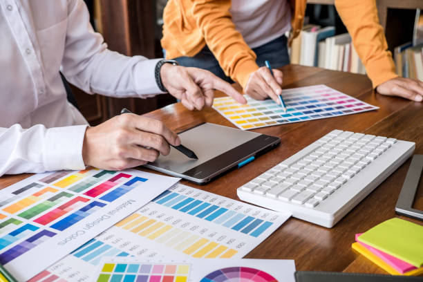 istock Two colleagues creative graphic designer working on color selection and drawing on graphics tablet at workplace 1131993226