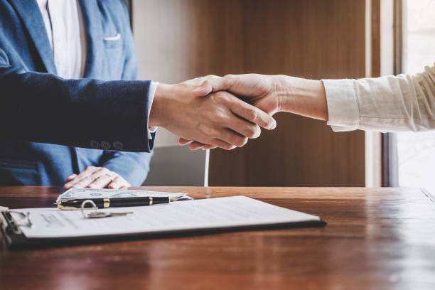 istock Real estate agent and customers shaking hands together celebrating finished contract after about home insurance and investment loan, handshake and successful deal 1131993237