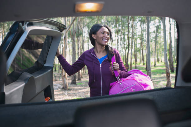 istock Woman unpacking car trunk. 1131995791