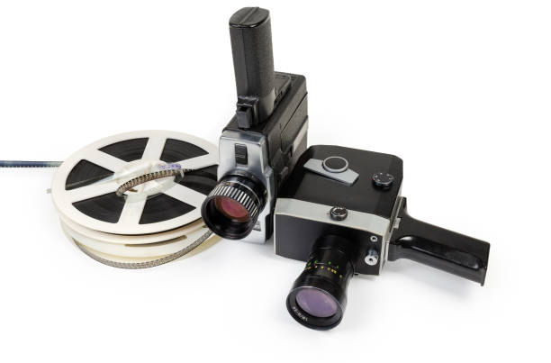 Two vintage amateur movie cameras and Super 8 mm films reels Two different vintage amateur film movie cameras and reels of color motion picture films Super 8 mm format close-up on a white background vintage amateur movie camera stock pictures, royalty-free photos & images