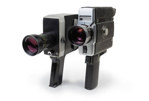Vintage amateur mechanical and electric movie cameras on white background Two old vintage amateur film movie cameras Super 8 mm format powered by clockwork motor and electric motor on a white background vintage amateur movie camera stock pictures, royalty-free photos & images