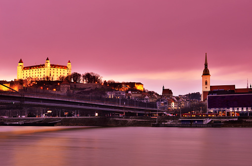 Bratislava cityscape at sunset in dramatic pink sky, Slovakia.