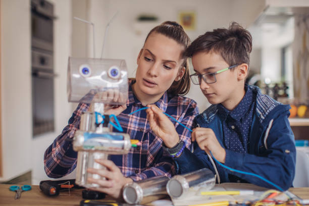 istock Big sister and little brother making a robot together 1131996976