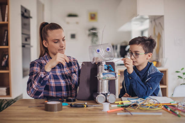 istock Sister and little brother making a robot at home 1131997075