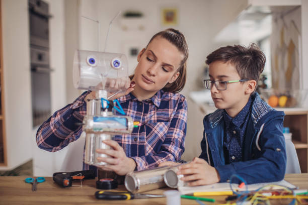 istock Brother and sister constructing a robot at home 1131997198