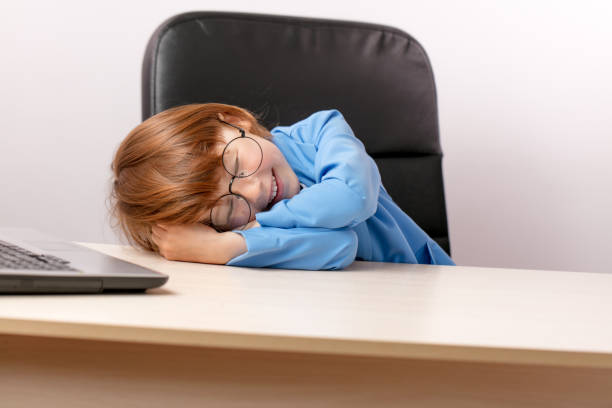 istock smiling ginger boy is sleeping in the office 1131998167